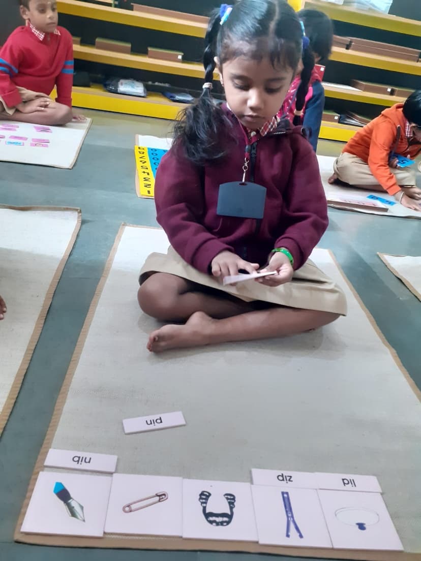 Child learning phonics with hands-on picture-word matching